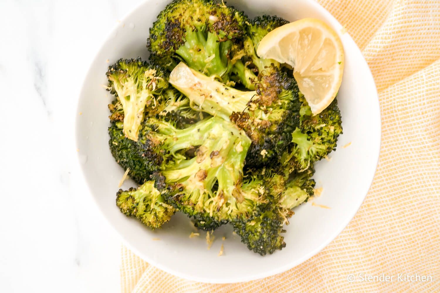 Baked broccoli with garlic and lemon in a bowl.