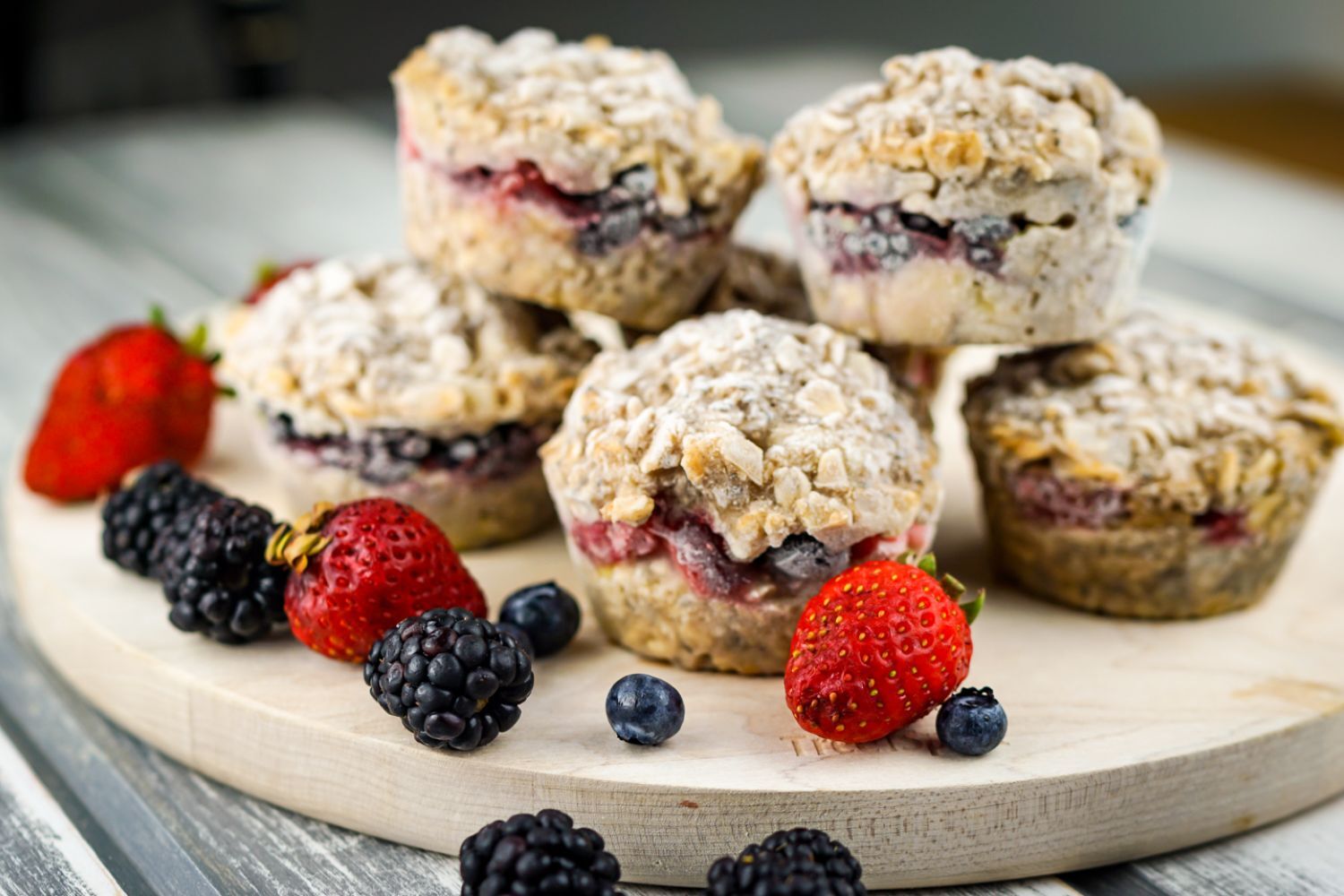 Frozen oatmeal cups piled up with berries.