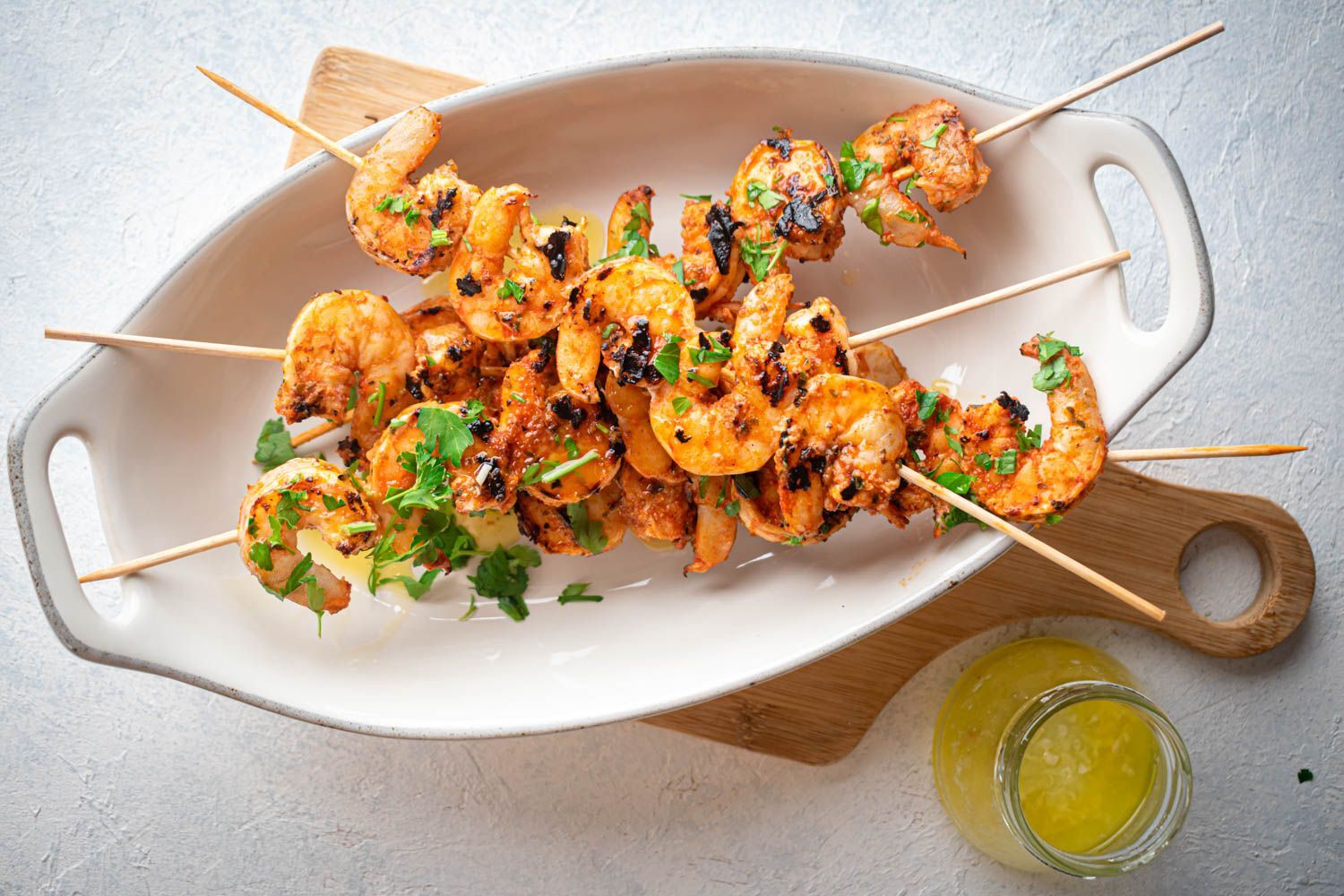 Garlic grilled shrimp on wooden skewers with spices, lemon juice, and melted butter.