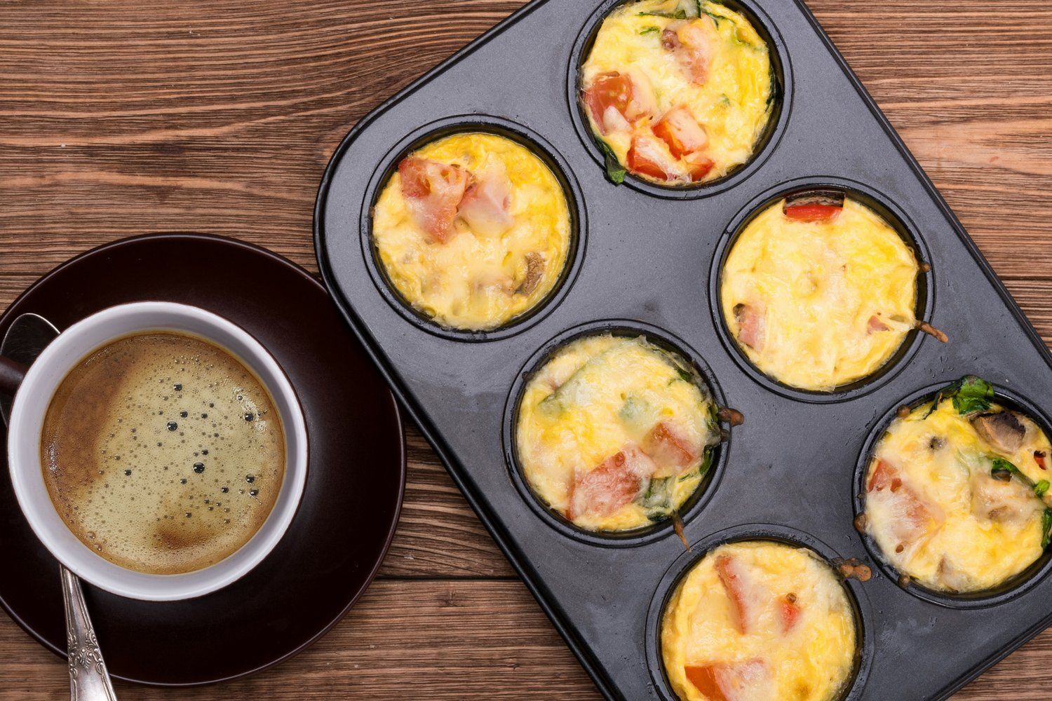 Egg Muffins with ham and cheese in a muffin tin.