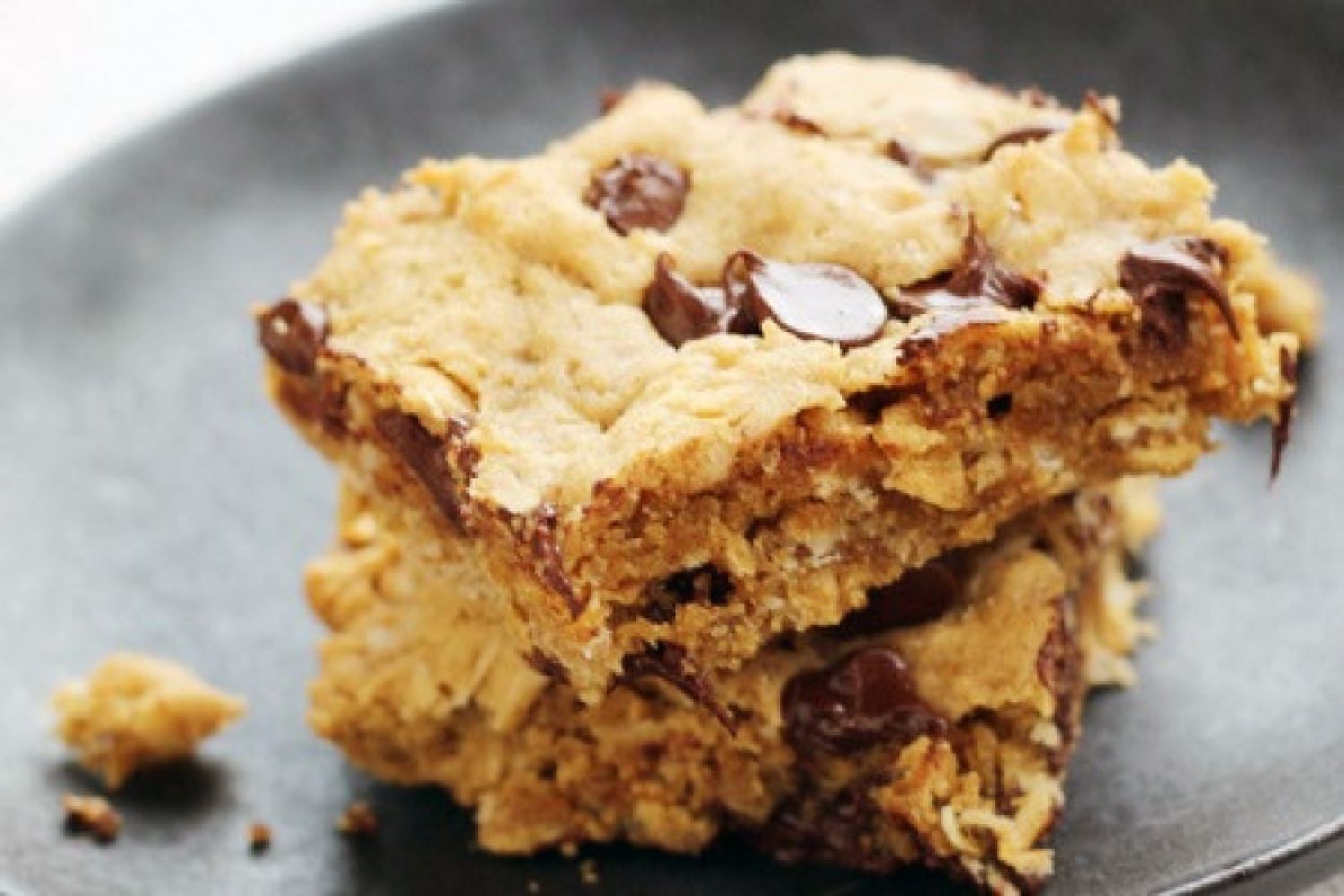 Peanut Butter chocolate chip oatmeal bars with whole grain oats on a plate.