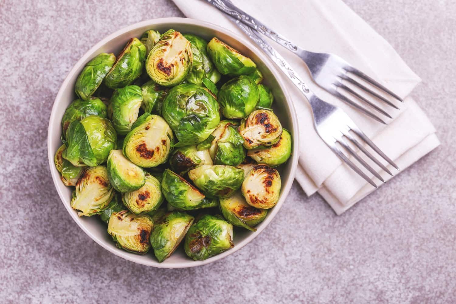 Simple roasted brussels sprouts in a bowl with charred edges.