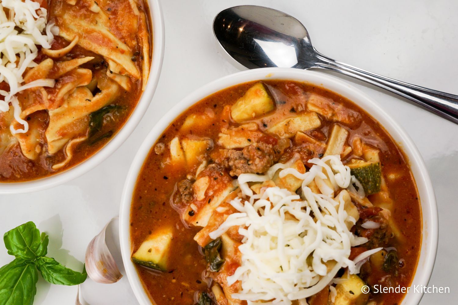 Slow Cooker lasagna soup in a crockpot with noodles, beef, and zucchini.