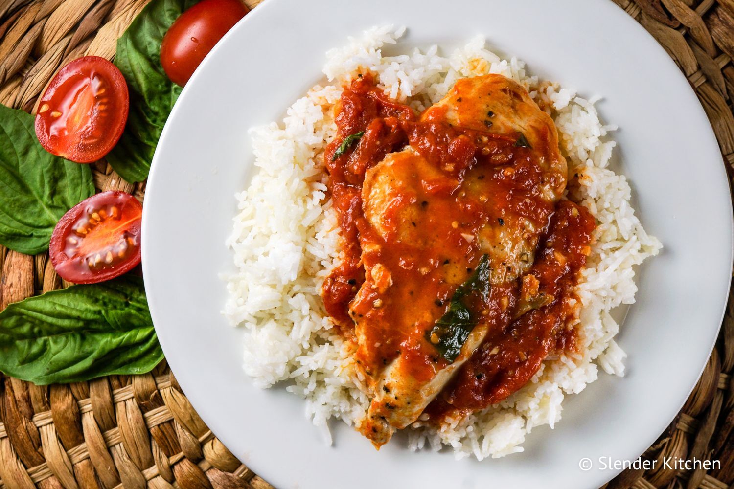 Tomato basil chicken with chicken breast served in a hearty tomato sauce with basil served over rice.