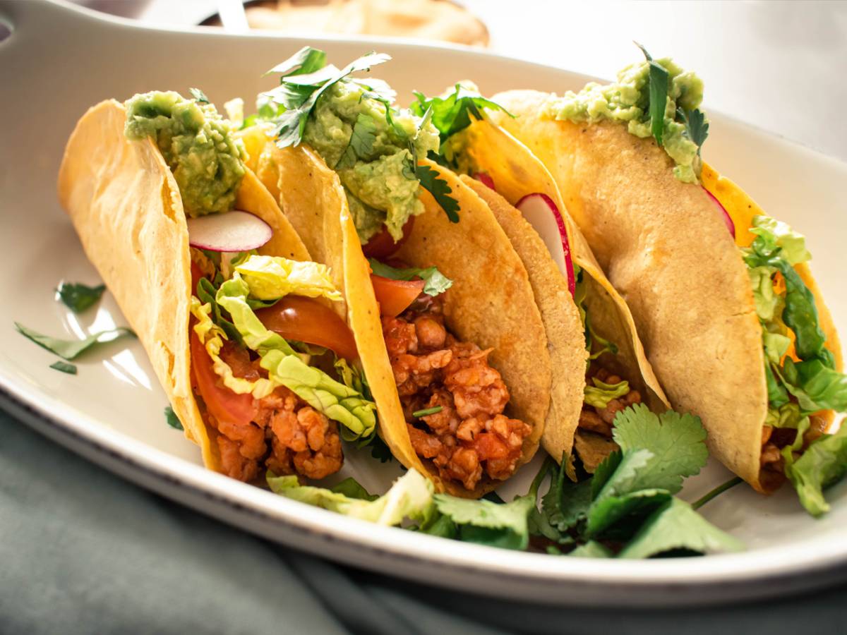 Ground turkey tacos in crispy baked tortillas with salsa, lettuce, radishes, and guacamole.