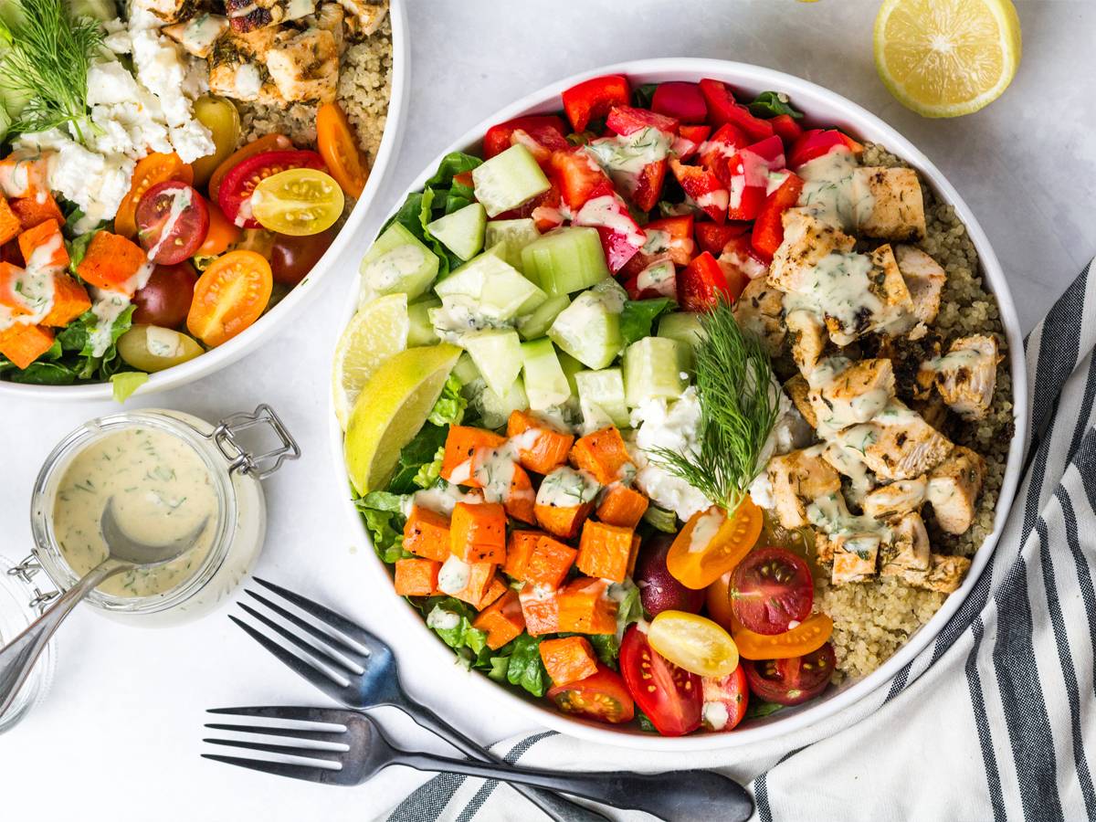 Mediterranean Bowls with chicken, cucumbers, red peppers, feta cheese, sweet potatoes, and tahini dressing.