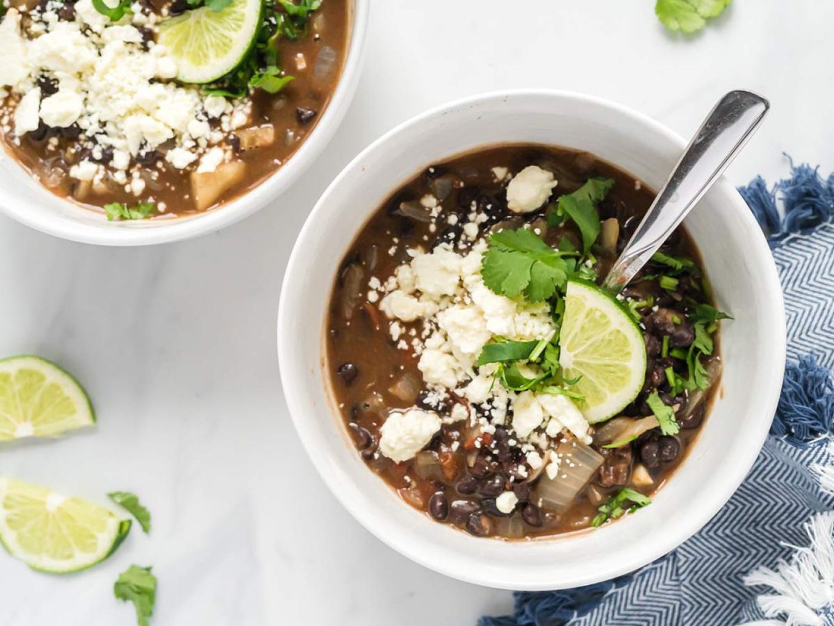 Black Bean Soup with Cheese in a White Bowl