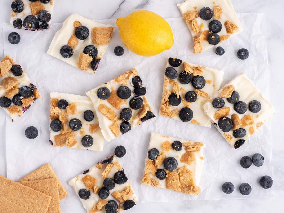 Blueberry Lemon Frozen Yogurt Bark with Graham Crackers on a White Board