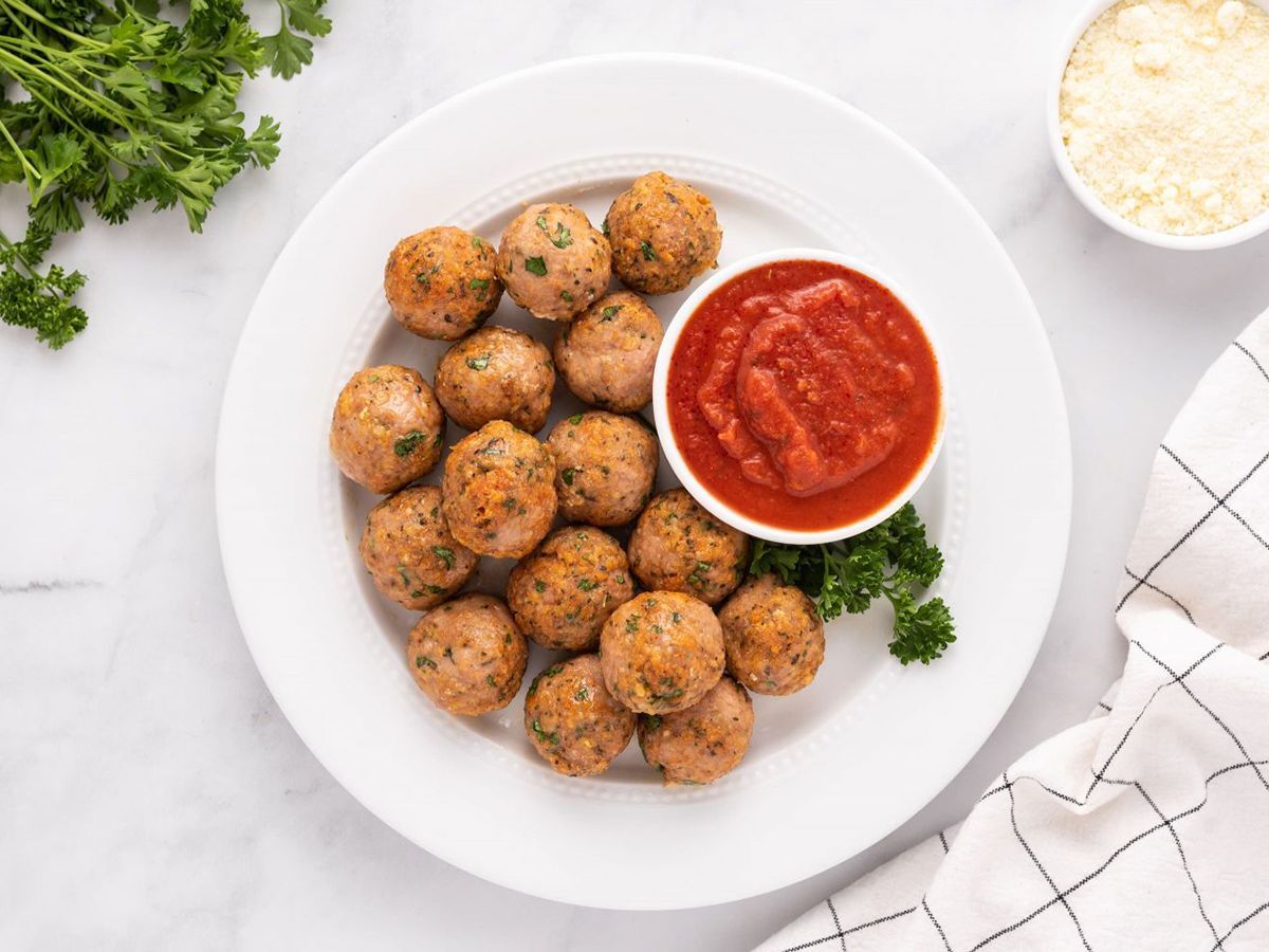 Turkey Meatballs on a white plate accompanied with sauce