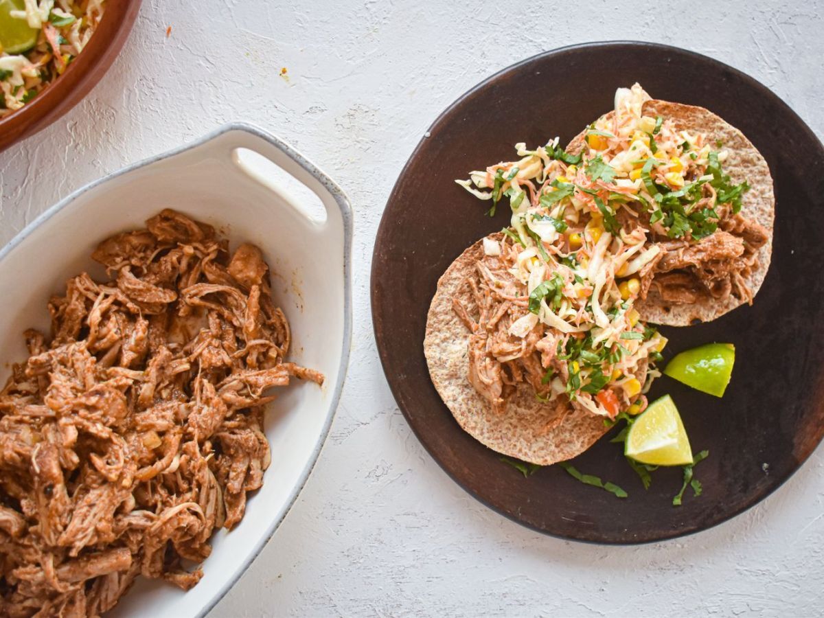 Slow Cooker Chorizo Spiced Pulled Pork in a corn tortilla with cabbage slaw.