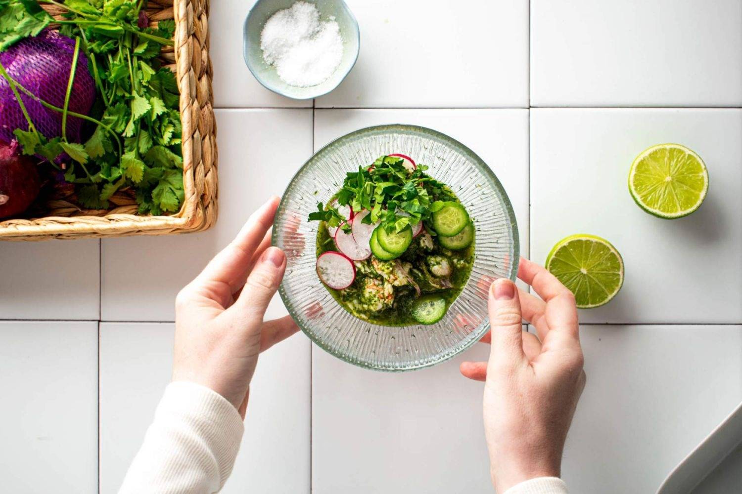 Mexican shrimp aguachile on a glass bow, shrimp, lime juice, coriander and cucumber.