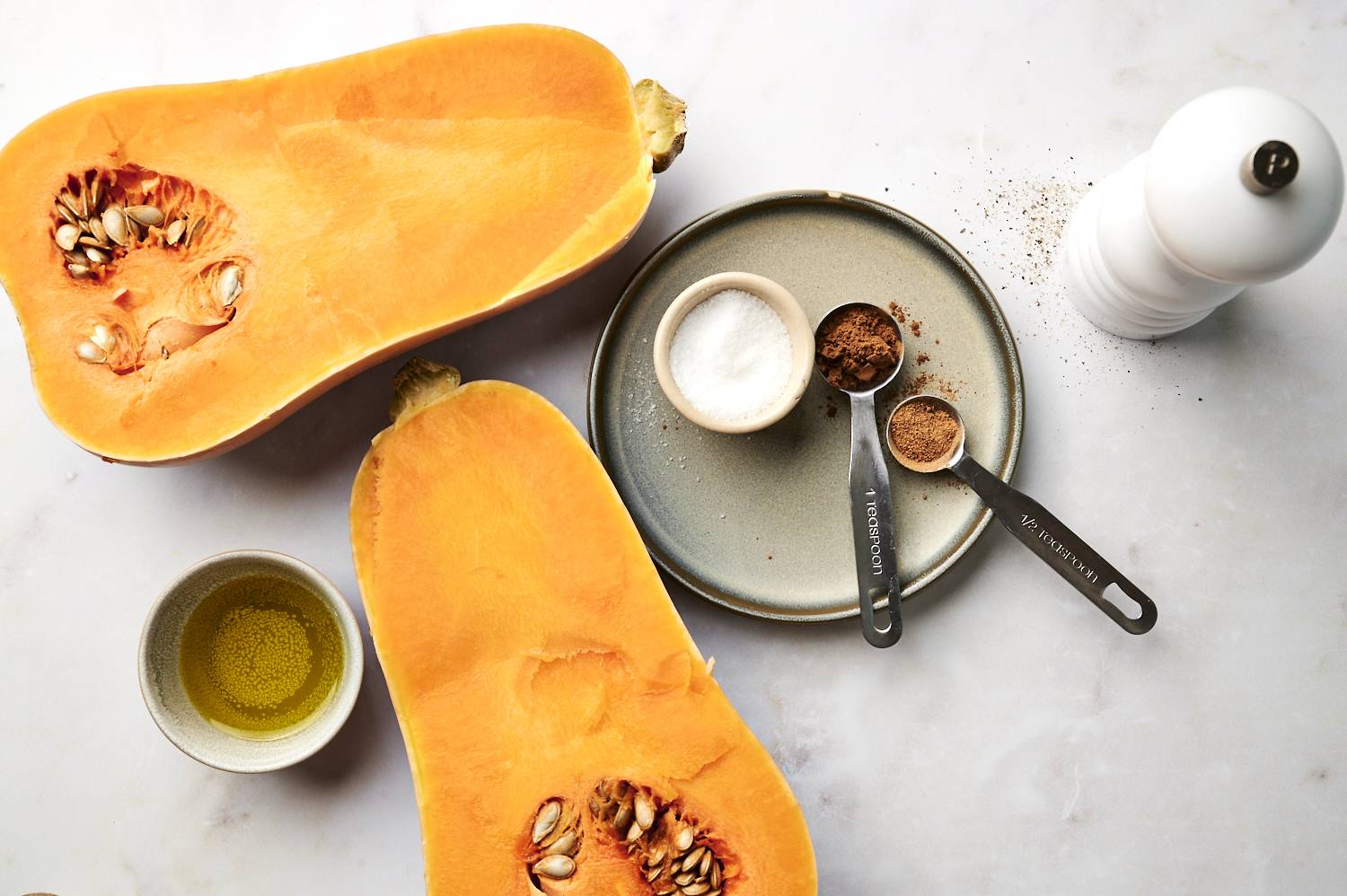 Sliced squash and spices on a table. 