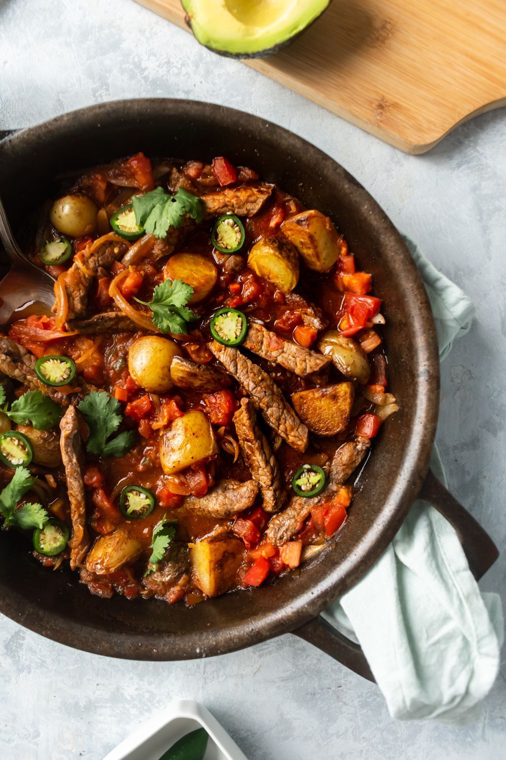 Rancher steak, thin strips of sirloin steak cooked in a skillet with potatoes, peppers, tomatoes and cilantro.