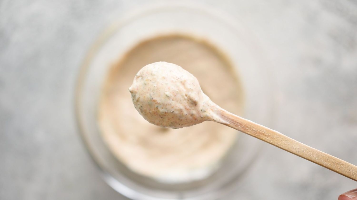 Serve on a wooden spoon with a ladle of blackened ranch dressing and garnish with herbs and spices.