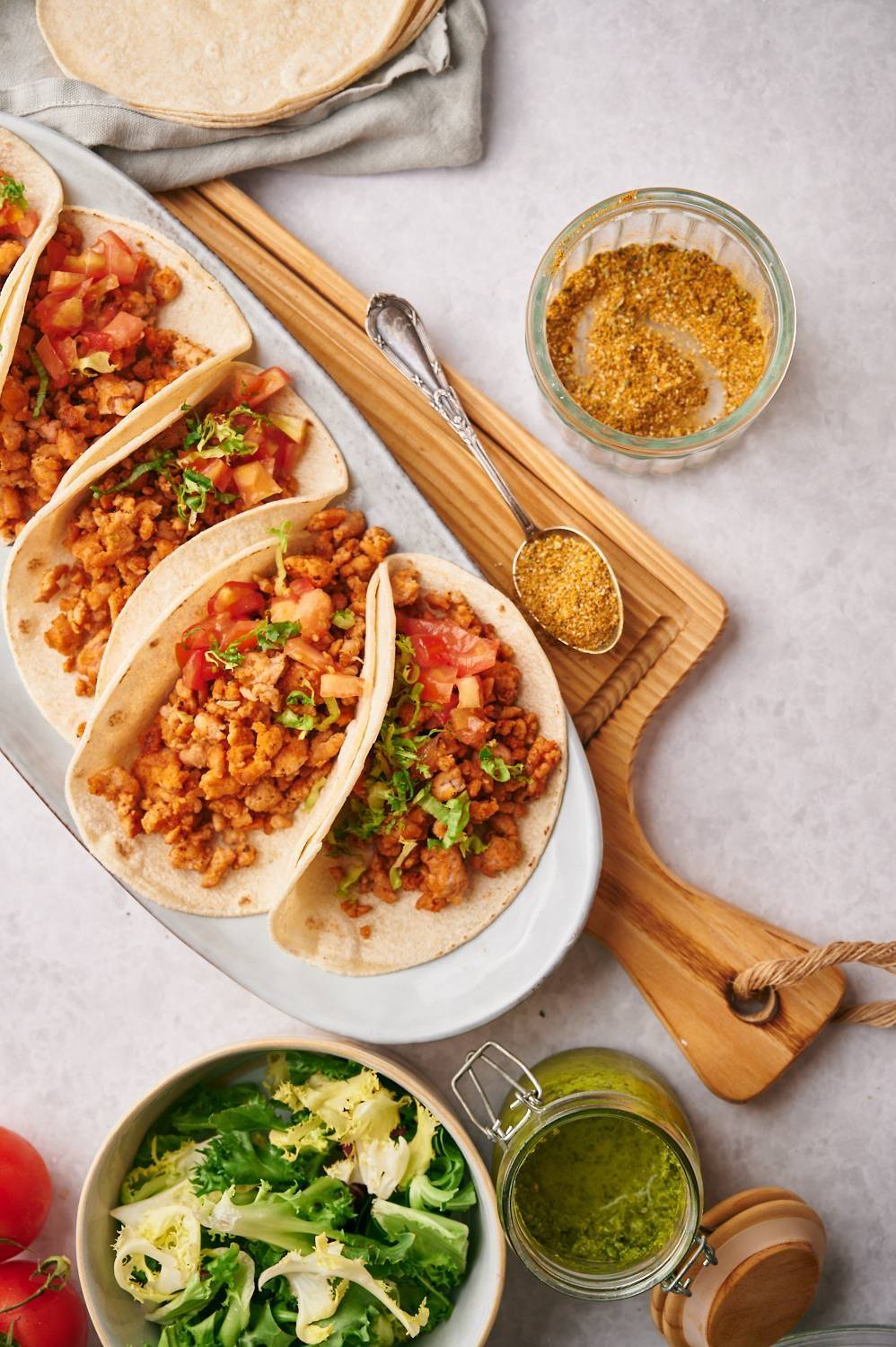 Ground chicken tacos and homemade taco seasoning in flour tortillas, tomatoes and cilantro.