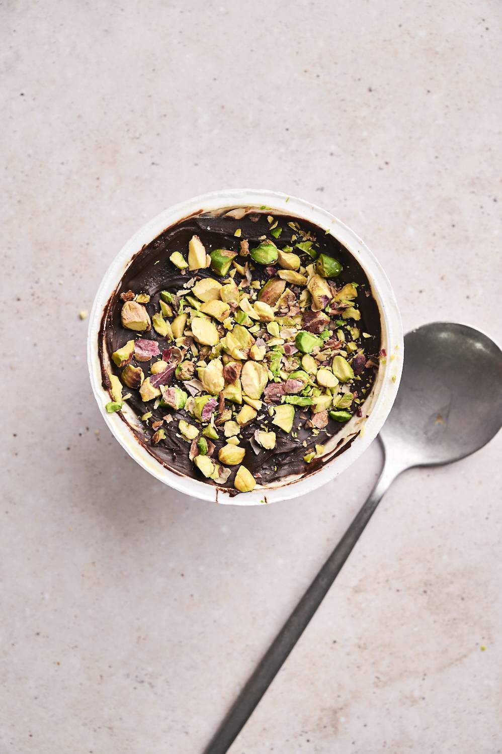 Close-up of finished Dubai chocolate yogurt cup showing nuts and date fill.