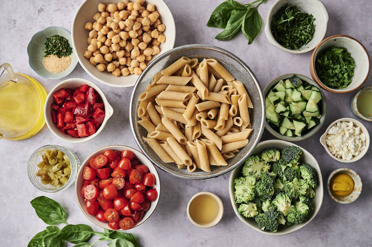 Ingredients for a variety of healthy meals, including whole grain pasta, chickpeas, tomatoes, broccoli and a variety of vegetables.