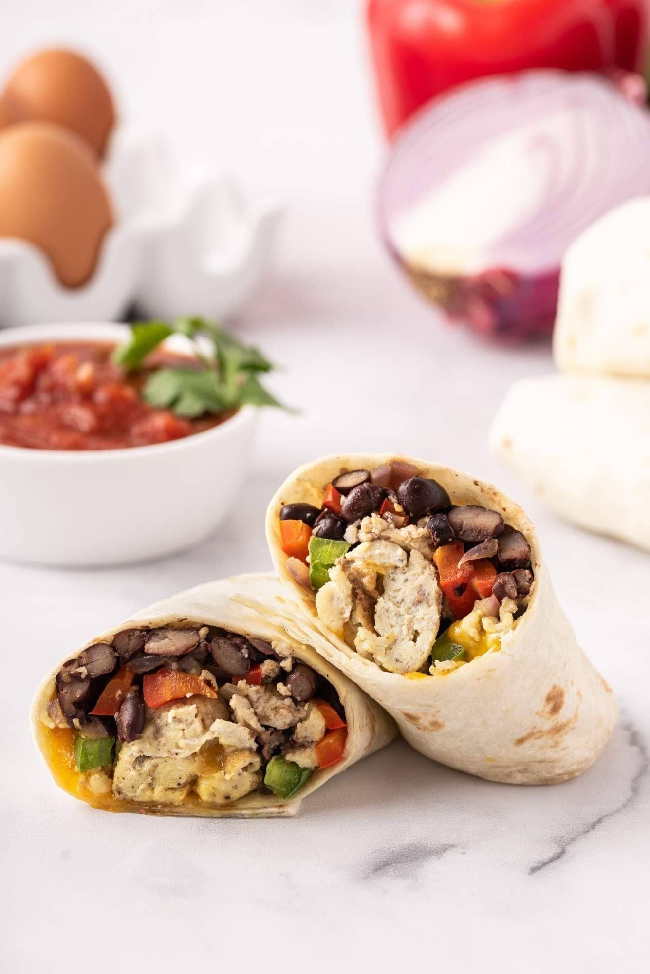 Egg burritos with black beans, chili and scrambled eggs wrapped in tortillas and cheese.