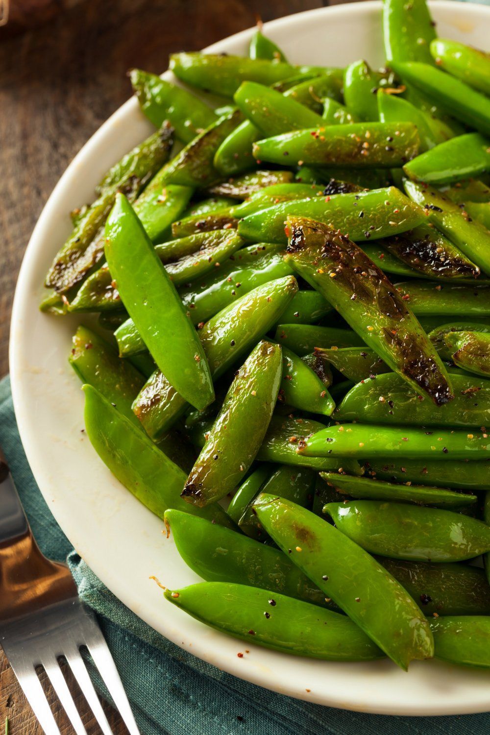 Place sugar snap peas on a plate and sauté until light brown.
