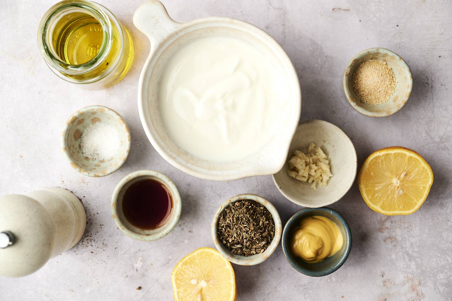 Ingredients for Greek salad dressing include yogurt, olive oil, garlic, herbs, mustard and lemon.