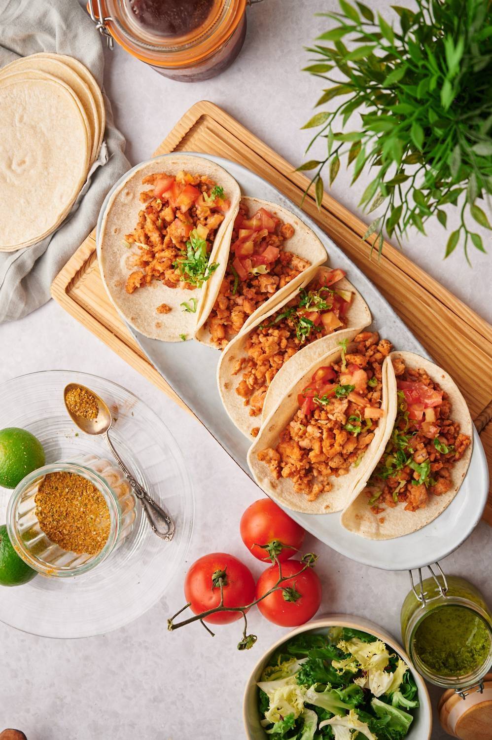 Chicken Tacos with chicken, tomatoes, coriander, lettuce and tortillas.