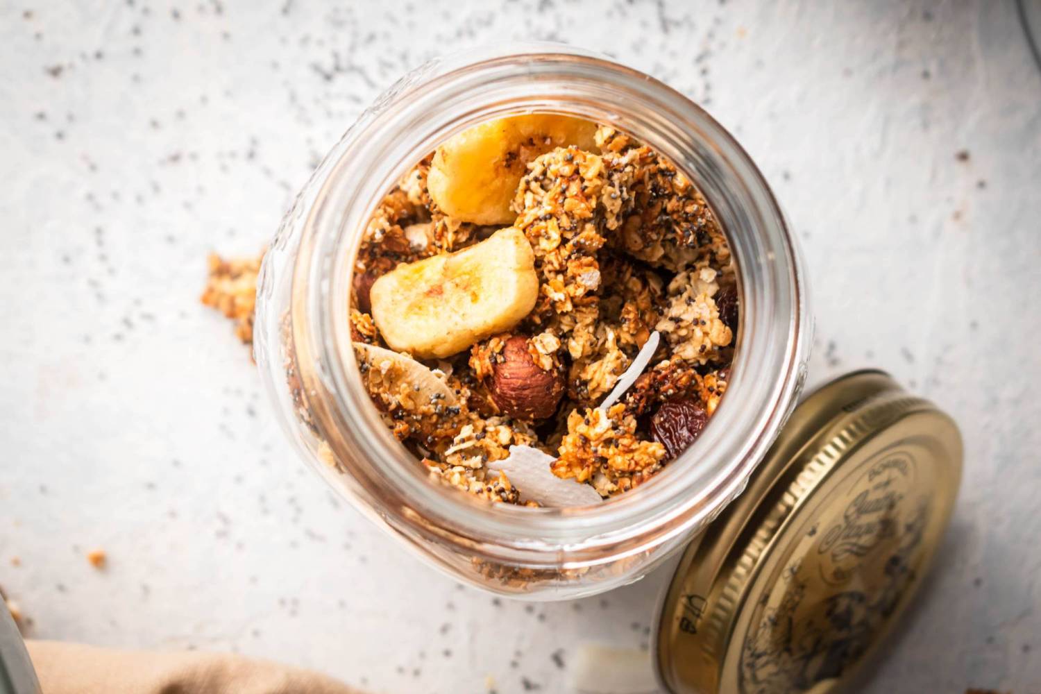 Granola with coconut, bananas, hazel nuts, chia seeds, and dried cranberries.