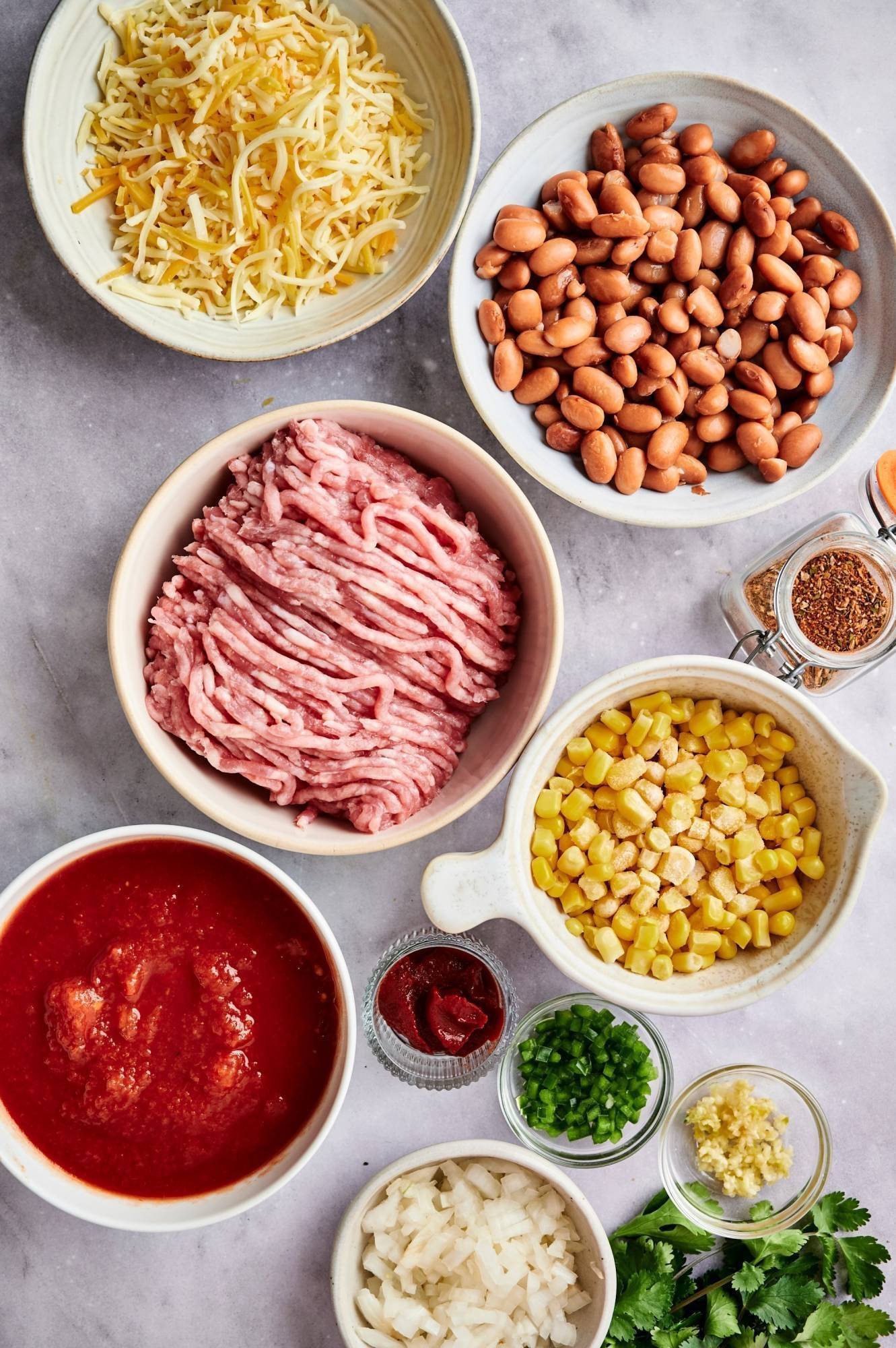 Ingredients for taco casserole include ground turkey, pinto beans, spices, cheese, taco seasoning and salsa.