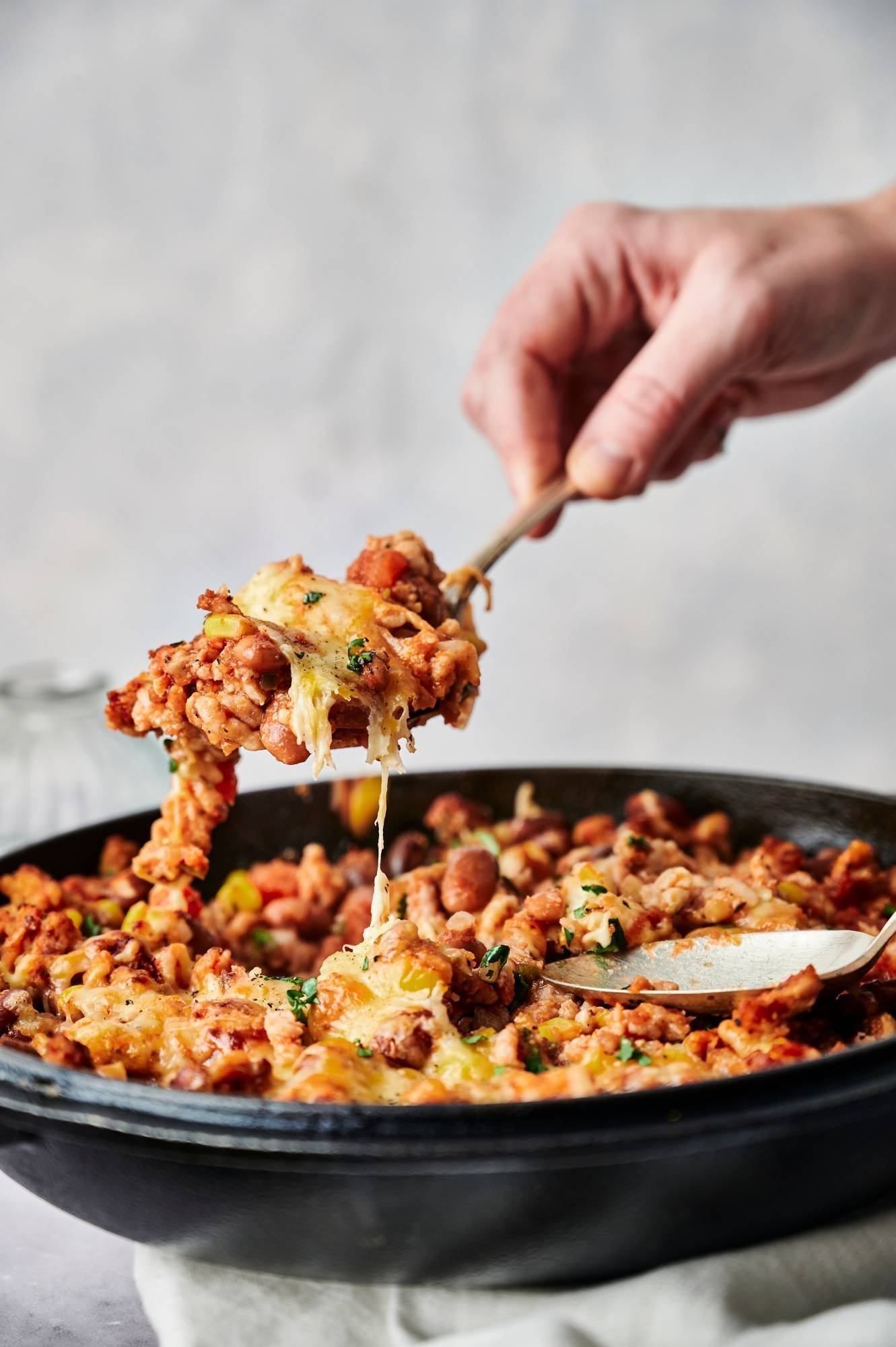 For a healthy taco casserole, spoon in ground turkey and pinto beans.