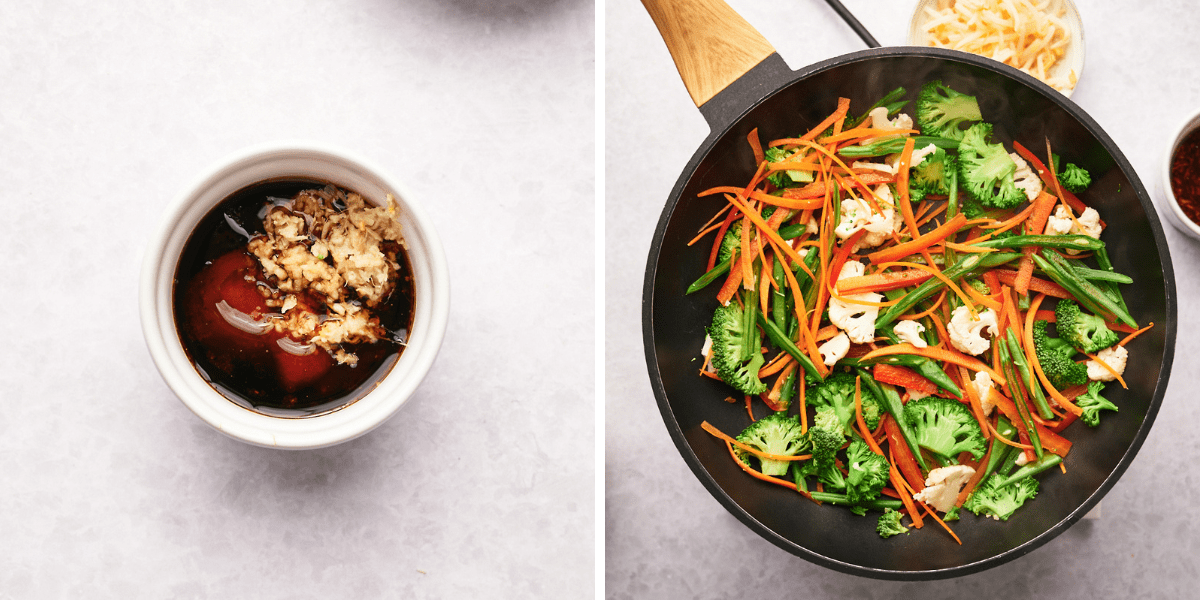 A bowl of sauce, next to the chopped garlic is a piece of vibrant stir-fry vegetables including broccoli, carrots and cauliflower.