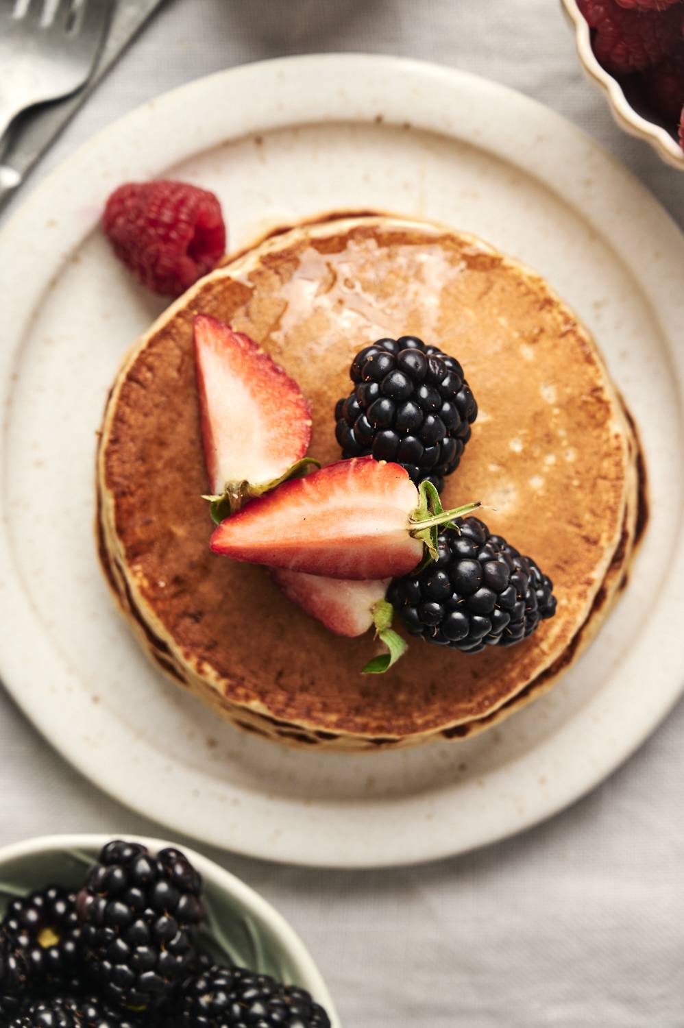 Golden, fluffy pancakes topped with fresh berries.