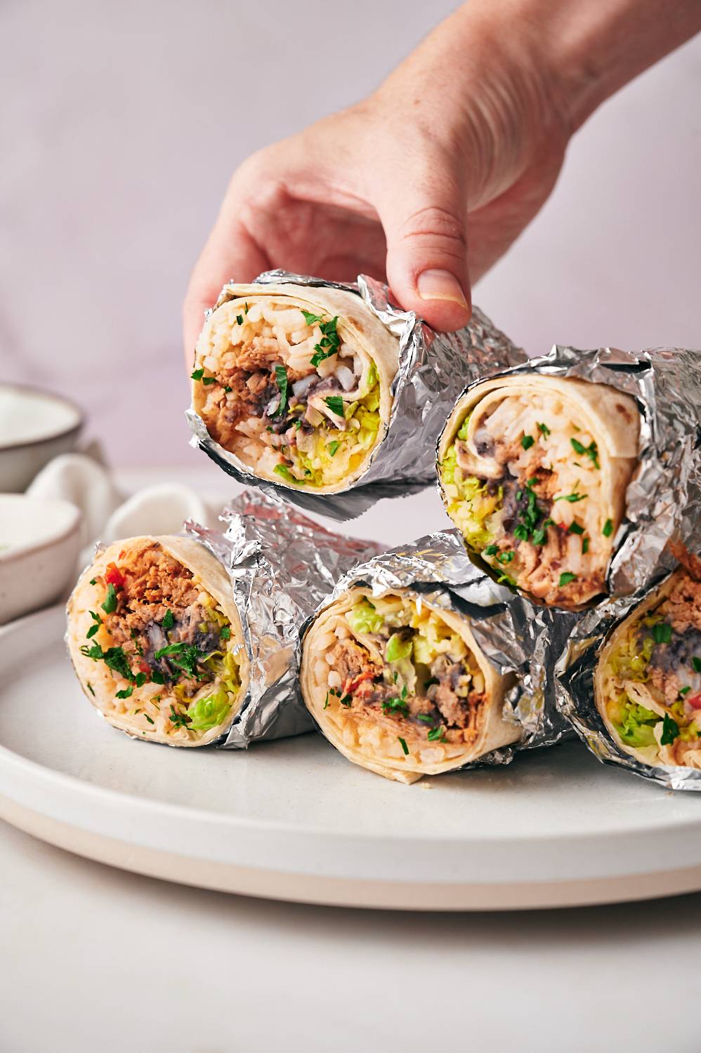 Mexican Machaca burritos with flour tortillas, rice, beans, lettuce, coriander and cheese.