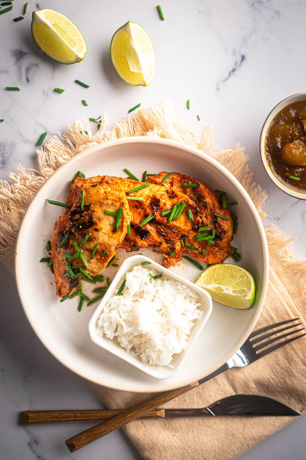 Chili powder chicken breast with garlic and lemon juice with white rice, shallot and mango chutney. 