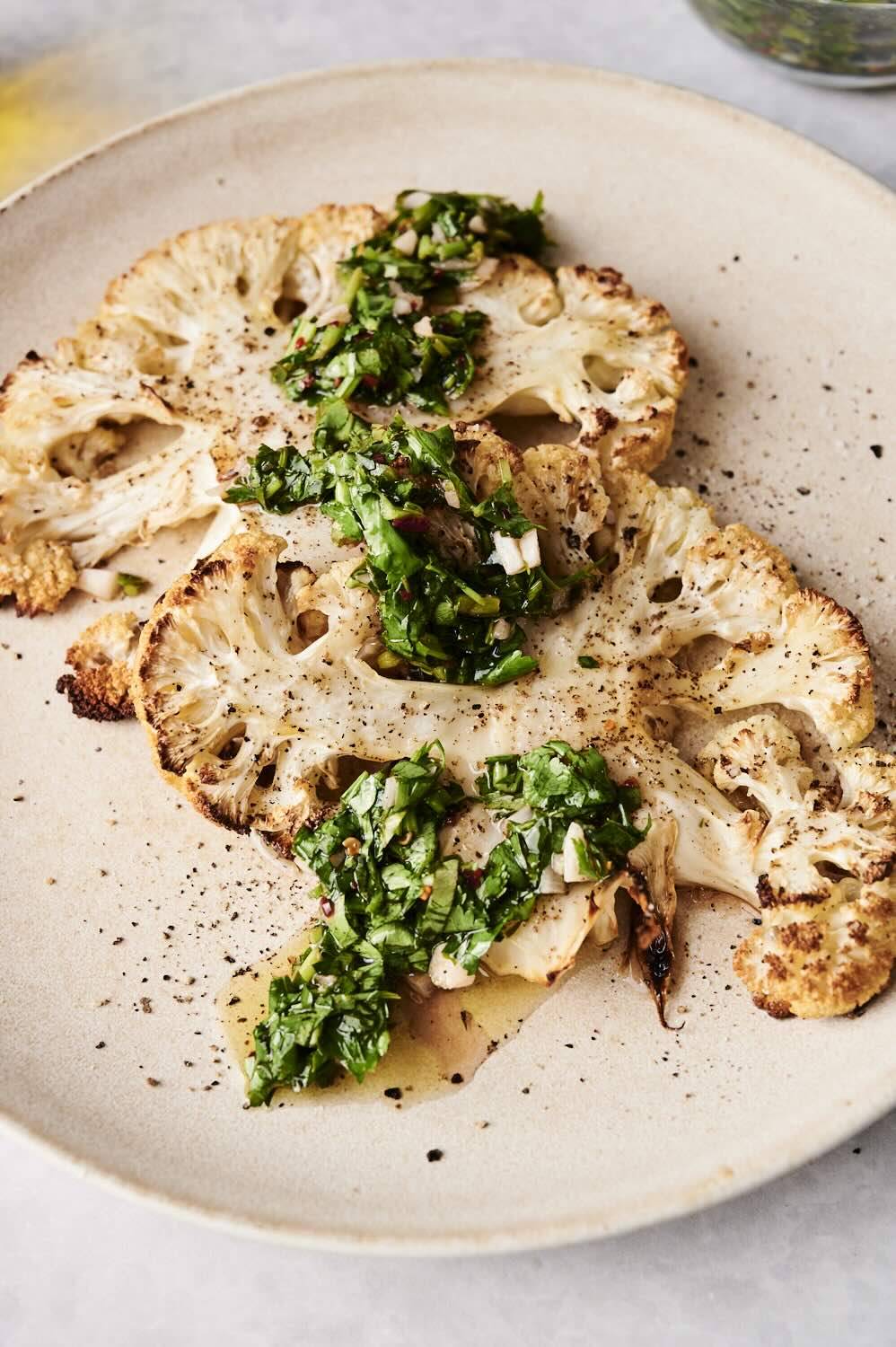 Roasted cauliflower steak with green green chili sauce and black pepper.