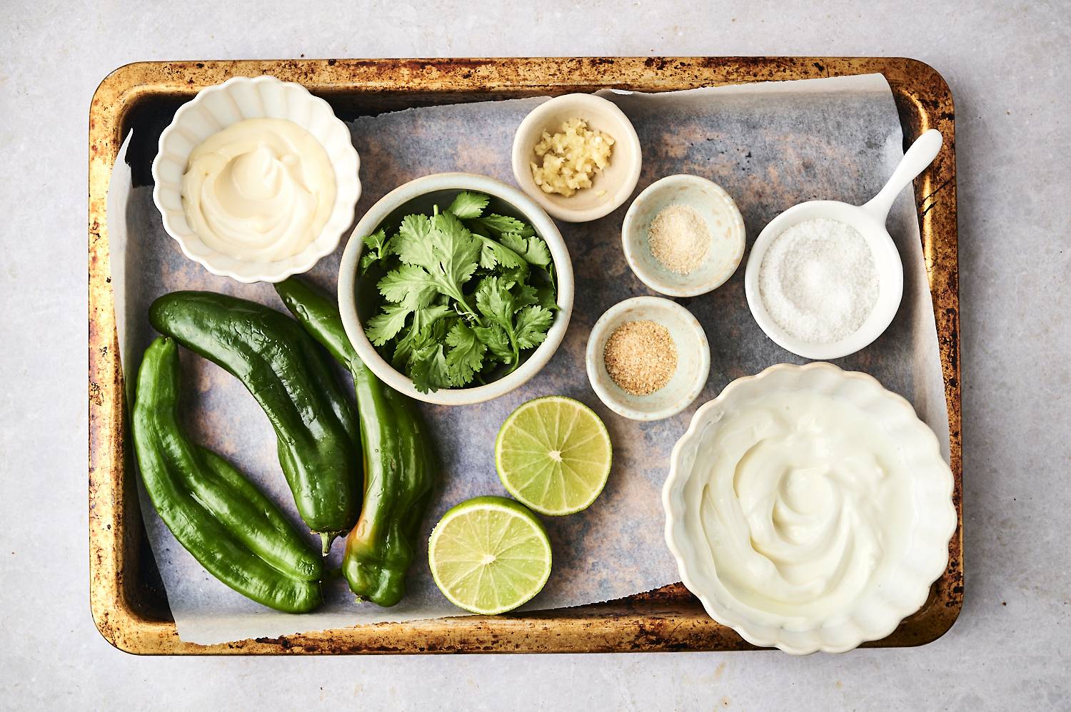 The tray shows fresh green chili, lime half, coriander, garlic, mayonnaise and various seasonings.
