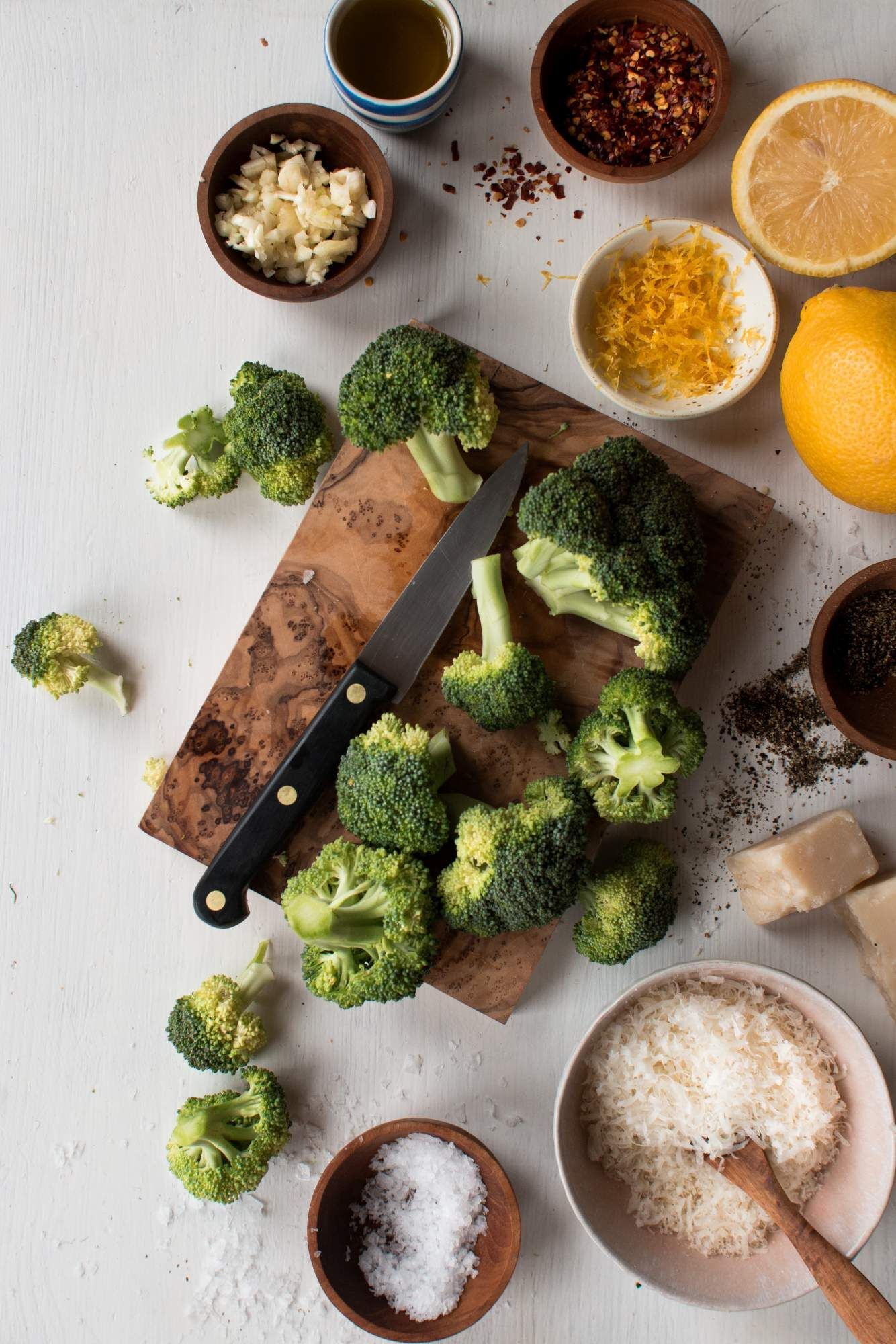 Ingredients for sauteed broccoli include broccoli florets, olive oil, garlic, red pepper flakes, Parmesan cheese, and lemon.