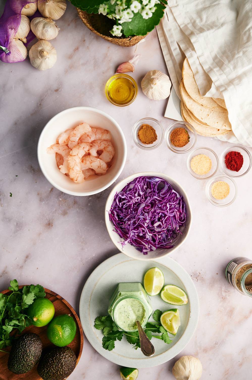 Ingredients for shrimp tacos include raw shrimp, chili powder, chili powder, garlic powder onion powder, salt, coriander, lemon juice and cabbage.