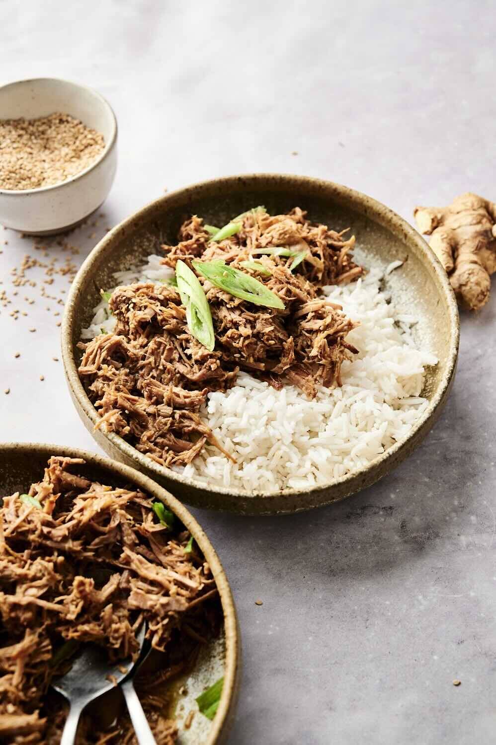 Sesame beef over rice with green onions, ready to enjoy.