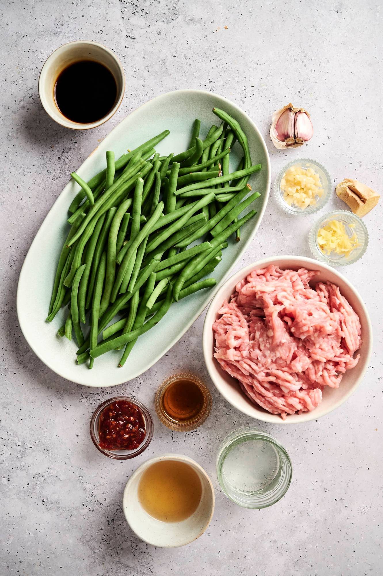 Ingredients for ground turkey stir fry with spicy stir fry sauce including green beans, ground turkey, soy sauce, garlic, ginger, coconut oil, sesame oil, and chili paste.