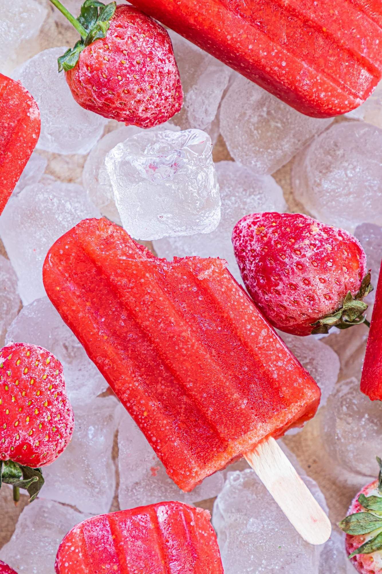 Homemade strawberry ice pops up to make chopped strawberries, honey served with frozen strawberries and ice.