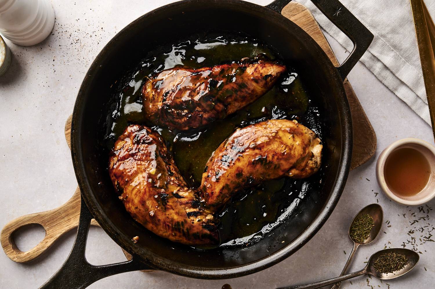 Turkey tenderloin in a cast iron skillet covered with maple mustard marinade.