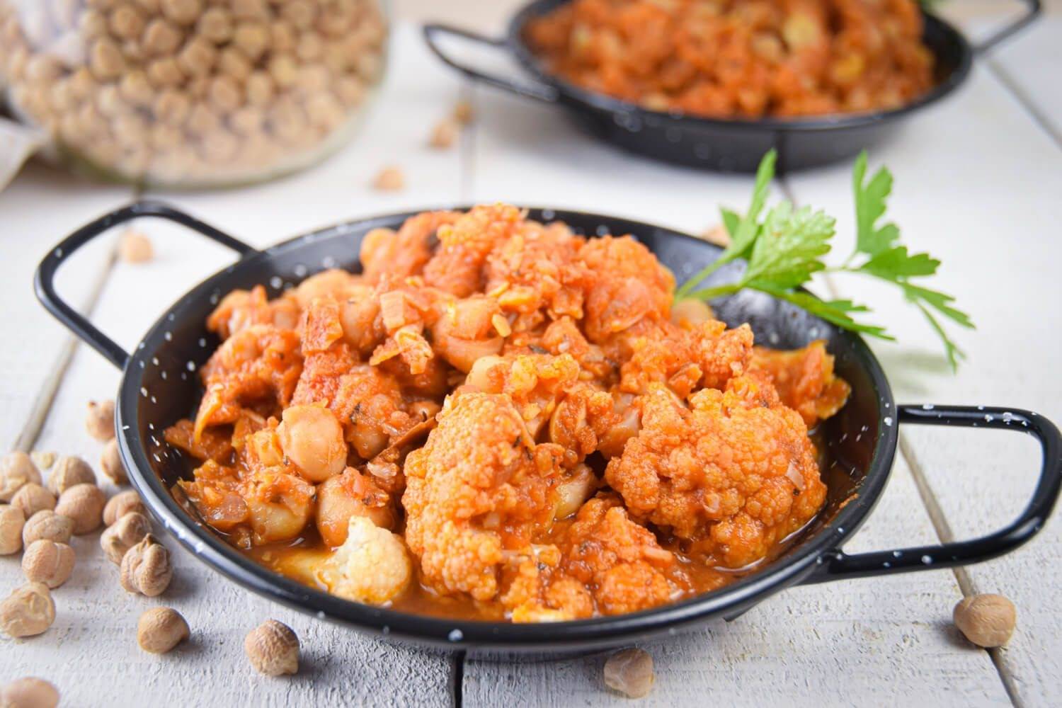 10 Easy and Delicious Slow Cooker Chickpea Recipes Slow cooker chickpea masala with cauliflower in tomato sauce with Indian spices and cilantro.