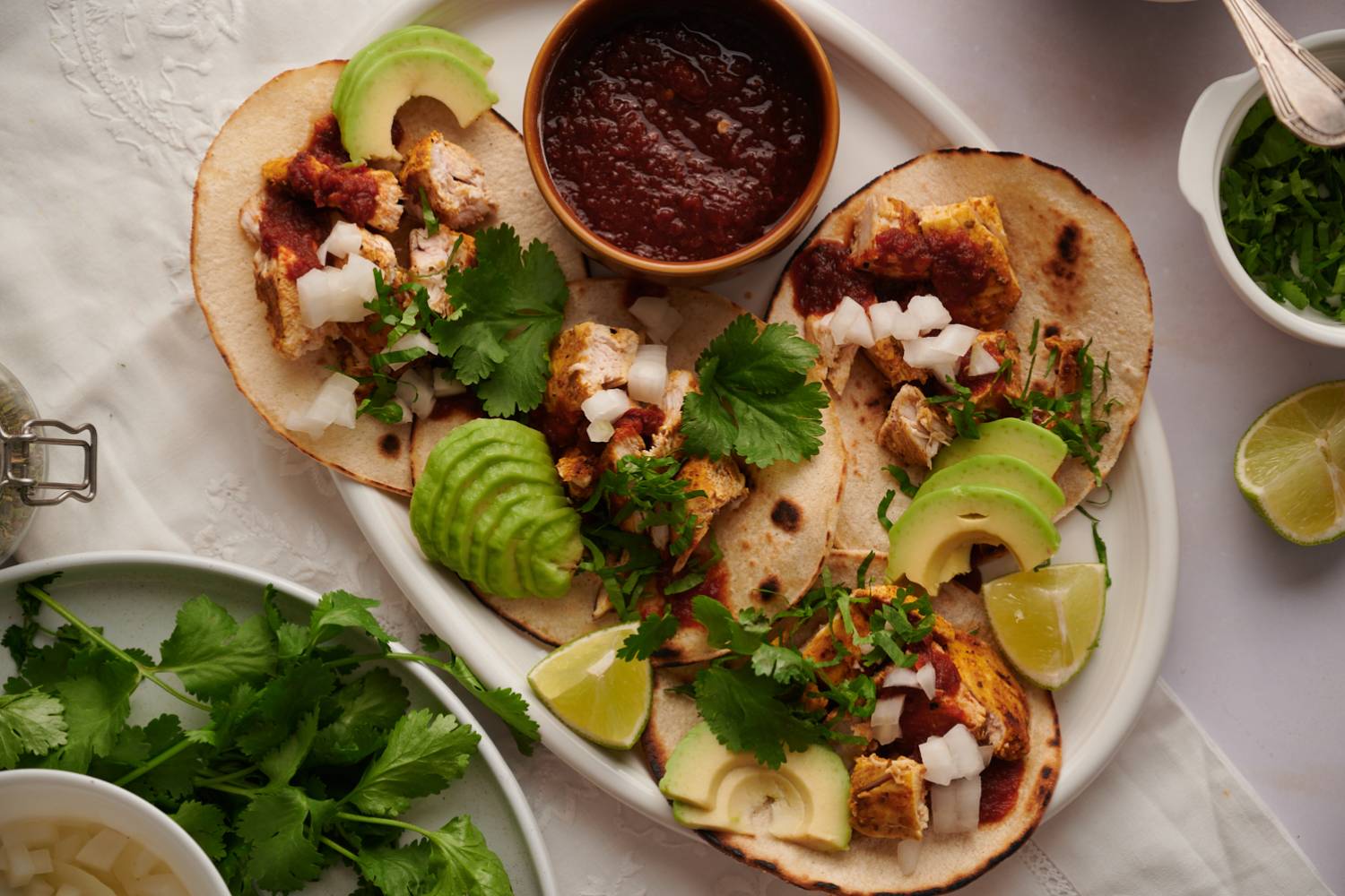 Grilled Chicken Tacos Grilled chicken tacos in a corn tortilla with cilantro and onion on top.