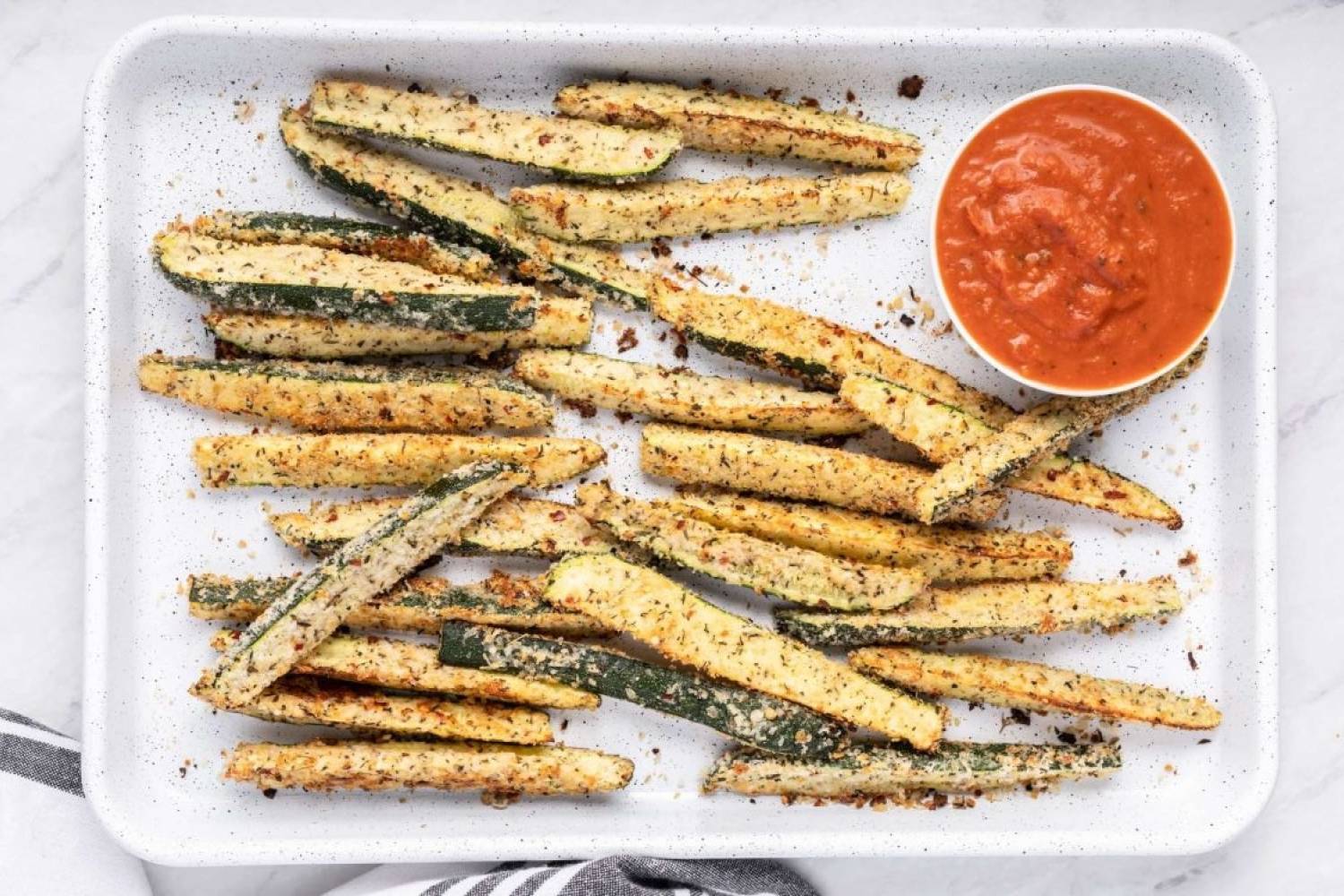 42 Low Carb Vegetable Side Dishes (15 g or less!) Low carb Parmesan zucchini fries with crispy edges served on a baking sheet with marinara sauce.