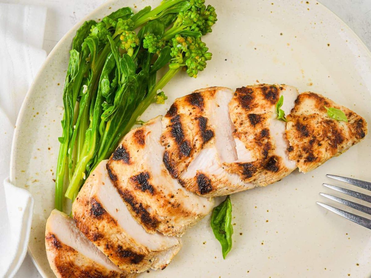 Healthy Grilling Recipes Grilled Chicken Breast with Basil and Broccolini on a plate.