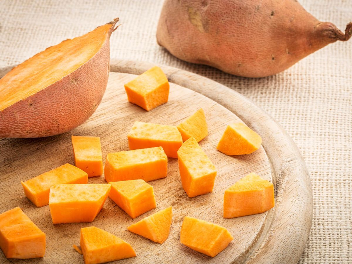 Diced sweet potato on a wood cutting board