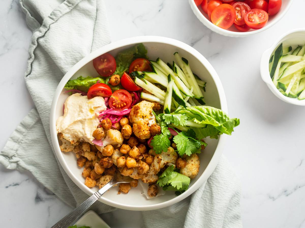 Vegetarian Vegetarain shawarma bowl with roasted chickpeas, cauliflower, and fresh vegetables.