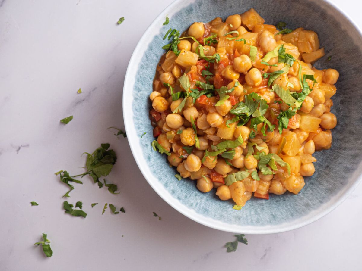 Slow Cooker Asian Recipes Sweet and Sour Chickpeas with Pineapple Served in a Round Bowl.