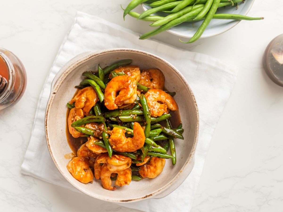 Teriyaki shrimp stir fry with green beans in a bowl with homemade sauce.